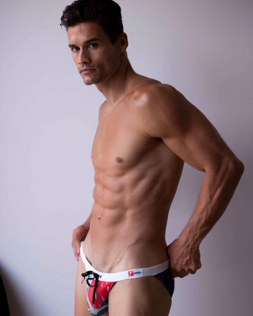 Model John Neda posing in Timoteo swimwear